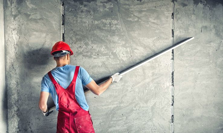 Construction worker installing sheetrock