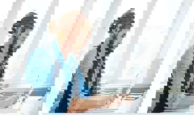 Man Typing a cover letter on a laptop