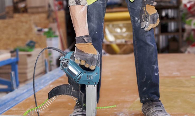Worker with a power tool