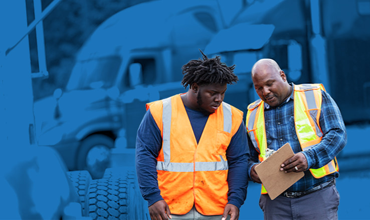 two men wearing hi-vis vests discussing their journeyman jobs 