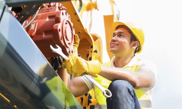 Guy working on heavy equipment